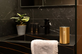 Champagne Gold Diffuser Go on top of a bathroom sink.