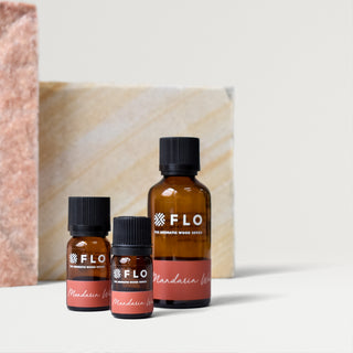 Bottles of 5ml, 10ml, and 50ml Mandarin Wood Essential Oil Blend.